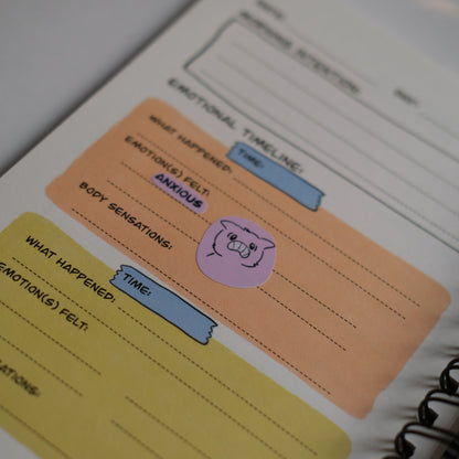 Notebook with colorful sticky notes on a plain background
